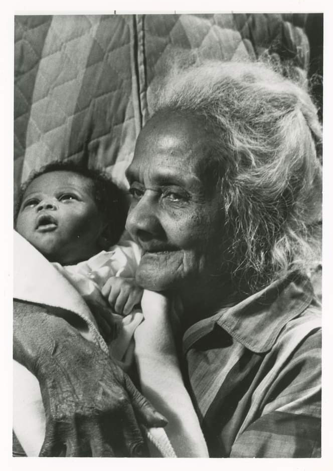 Midwife Bennie McGuire holding a baby